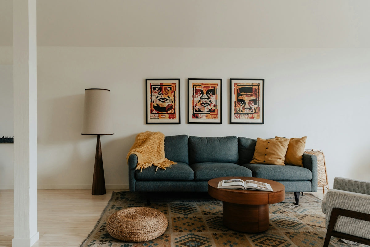 A living room filled with furniture and a painting on the wall